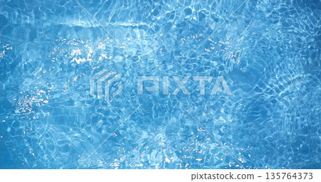 Glistening Blue Water, Bright Sunlight Causes Shimmering Patterns On Gentle Moving Water Of Backyard Pool 135764373