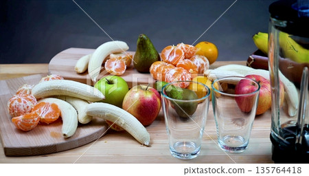 Fruits On Wooden Table, Colorful Fruit Arrangement With Beverages, Fresh Produce And Drinks Set For Breakfast 135764418
