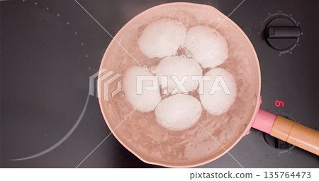 Milk Dumplings Simmering, Home Cook Lovingly Preparing Warm Milk With Soft Dumplings In Old Copper Pan 135764473