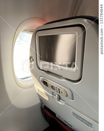 View from inside the airplane cabin of the window and seat View from inside the airplane cabin of the window and seat 135764644