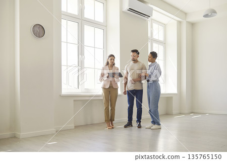 Woman realtor showing future tenants modern apartment for living 135765150