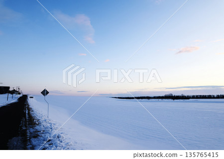 Snowfield and sunrise 135765415