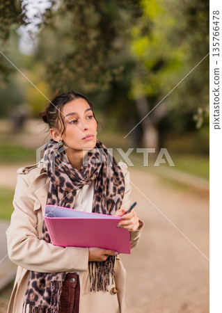 Woman volunteer collecting signatures for social cause 135766478
