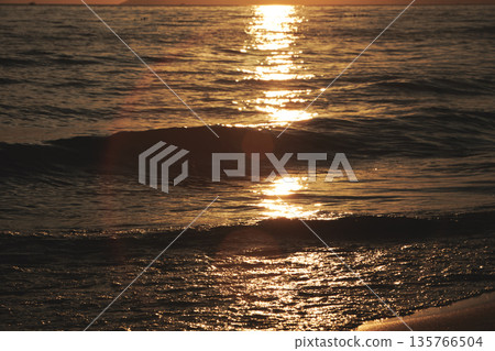 Vlora, Albania August , 2025 Sunset reflections on the shoreline as gentle waves wash over the sand, capturing warm golden light and peaceful evening scenery on the Adriatic coast. Vlora, Albania August , 2025 Sunset reflections on the shoreline as gentle waves wash over the sand, capturing warm golden light and peaceful evening scenery on the Adriatic coast. 135766504