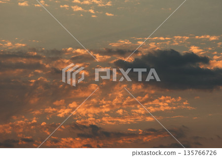 Soft golden sunset clouds over Vlora, Albania on August 2025, with a lone bird gliding across the sky in a peaceful minimalistic scene. Soft golden sunset clouds over Vlora, Albania on August 2025, with a lone bird gliding across the sky in a peaceful minimalistic scene. 135766726
