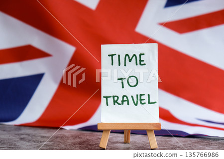 Paper note with words TIME TO TRAVEL on National symbol of Great Britain. British wave the UK silky flag background. Travel destination tourism Paper note with words TIME TO TRAVEL on National symbol of Great Britain. British wave the UK silky flag background. Travel destination tourism 135766986