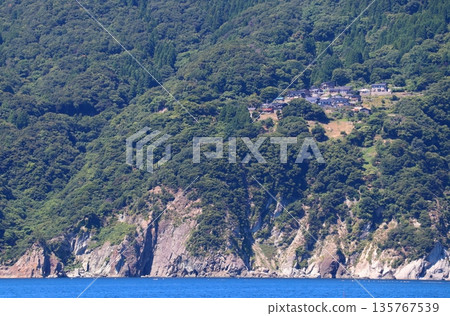 View of the San'in Coast Geopark from a pleasure boat: A village near Isasazaki (Yorubemisaki) 135767539