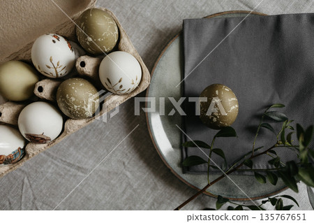 Easter holiday. Painted olive-colored eggs on a linen tablecloth. Easter decoration. Easter holiday. Painted olive-colored eggs on a linen tablecloth. Easter decoration. 135767651