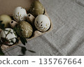 Easter holiday. Painted olive-colored eggs on a linen tablecloth. Easter decoration. 135767664