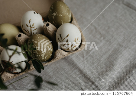 Easter holiday. Painted olive-colored eggs on a linen tablecloth. Easter decoration. Easter holiday. Painted olive-colored eggs on a linen tablecloth. Easter decoration. 135767664