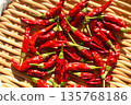 Drying the harvested bright red chili peppers 135768186