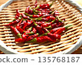 Drying the harvested bright red chili peppers 135768187