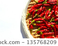 Drying the harvested bright red chili peppers 135768209
