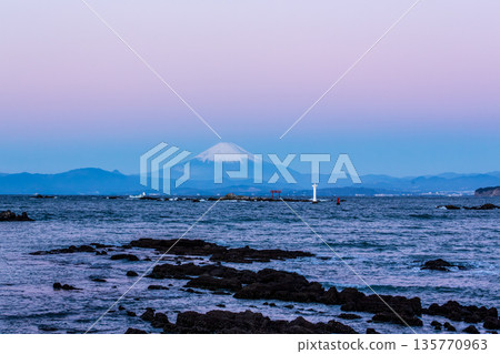 The shadow of the Earth at dawn and Mount Fuji dyed pink by the Venus Belt seen from Mase Coast in Hayama Town in winter 135770963