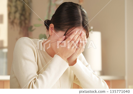 Shocked young woman covering her face 135771040
