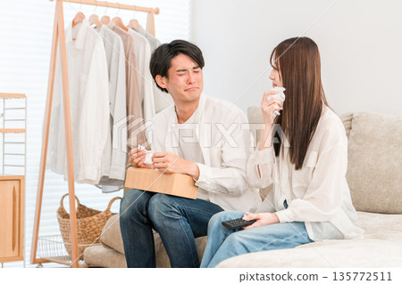 Young Asian couple watching TV on the sofa in the living room at home, couple (touching, tears, tearful) Young Asian couple watching TV on the sofa in the living room at home, couple (touching, tears, tearful) 135772511
