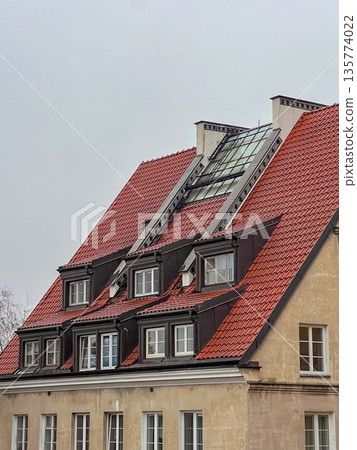 Building with red roof and glass feature in cloudy weather in urban area Building with red roof and glass feature in cloudy weather in urban area 135774022