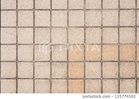 Square tile texture on outdoor sidewalk 135774502