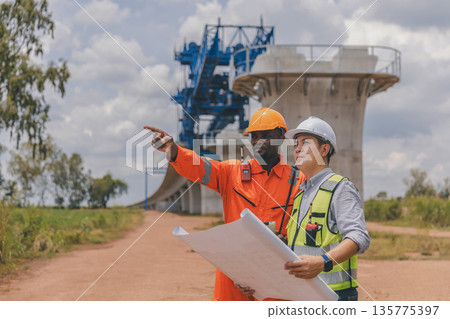Engineer survey team checking construction project inspection work construction site Engineer survey team checking construction project inspection work construction site 135775397