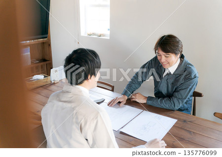 A man looking at documents and having a meeting 135776099