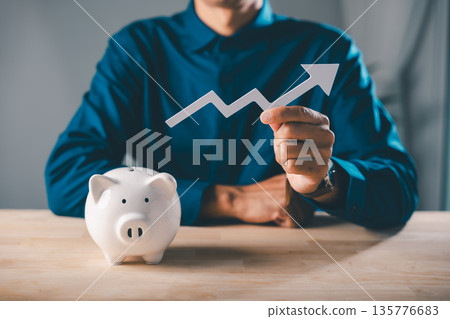 businessman uses piggy bank economy increase money wealth gambling pig report to plan saving investments, holding white arrow to show profit gain and long term financial growth 135776683