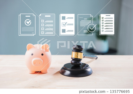 Legal salary compliance and banking transparency with money save taxation concepts appear near wooden judge gavel and pink piggy bank as digital document icons show finance audit 135776695