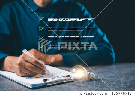Business manager uses light bulb innovation concept, creative vision, energy strategy, career project, document management with digital checklist, professional quality control Business manager uses light bulb innovation concept, creative vision, energy strategy, career project, document management with digital checklist, professional quality control 135776712
