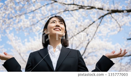 Portrait of a young businesswoman smiling broadly under the cherry blossoms 135777003