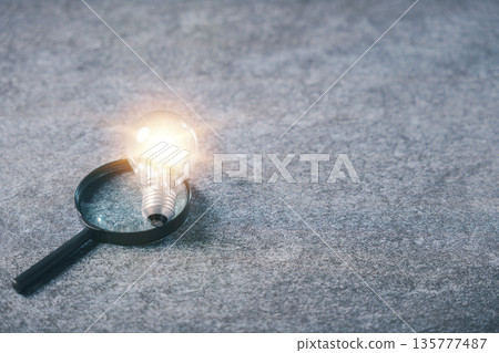 College career ideas shine through glowing lightbulb placed over magnifying glass for college innovation, search for creative insight leads to college career path success College career ideas shine through glowing lightbulb placed over magnifying glass for college innovation, search for creative insight leads to college career path success 135777487