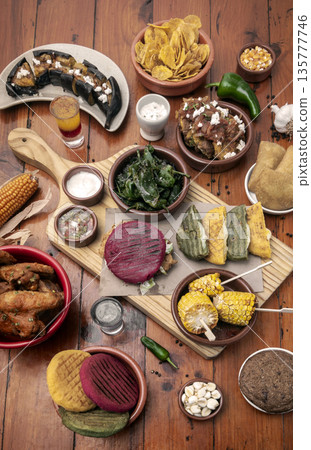 mixed colombian and venezuelan food meal spread on wooden restaurant table mixed colombian and venezuelan food meal spread on wooden restaurant table 135777746
