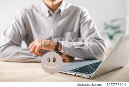 Positive customer feedback concept, happy client satisfaction survey online, person with laptop, smiling icon on desk, digital service review evaluation, top quality rating experience 135777824