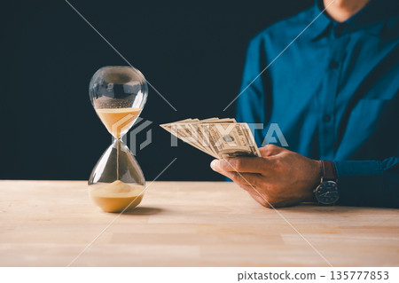 Money time hourglass shows business investment finance savings global economy, vital wealth management strategy for future financial planning and secure banking 135777853