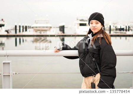 Young woman wearing a knitted hat 135778454