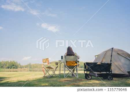 asian couple fun happy and relax with camping and picnic at side of lake with mountain background asian couple fun happy and relax with camping and picnic at side of lake with mountain background 135779046