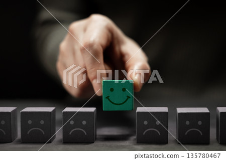 Mind, Mental Health Concept. Hand Picking a Unique Smiling Cube Mind, Mental Health Concept. Hand Picking a Unique Smiling Cube 135780467