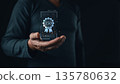 A person holds a glowing holographic certificate featuring an ISO badge, symbolizing international standards, quality assurance, compliance, and certification in modern digital business practices. 135780632