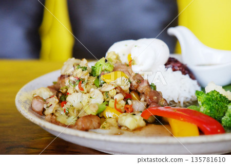 Close up stir-fried pork with cauliflower with boiled egg, fish sauce, broccoli and raspberry rice on a white plate Close up stir-fried pork with cauliflower with boiled egg, fish sauce, broccoli and raspberry rice on a white plate 135781610