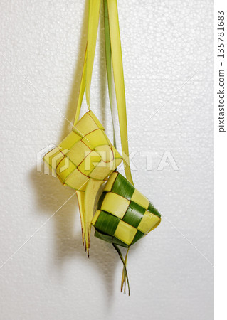 Traditional Woven Ketupat Decorations. Islamic Festival elements. Traditional Handmade Ketupat. Ramadan Celebration elements. High quality photo Traditional Woven Ketupat Decorations. Islamic Festival elements. Traditional Handmade Ketupat. Ramadan Celebration elements. High quality photo 135781683
