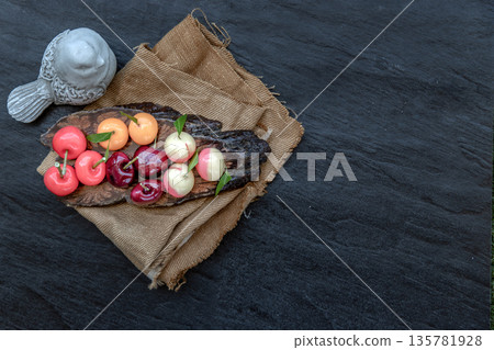 Kanom Look Choup : An old traditional thai dessert made from green been, coconut milk, sugar and jelly, Deletable imitation fruits made from green been, coconut milk, sugar and jelly in fruit shape on 135781928