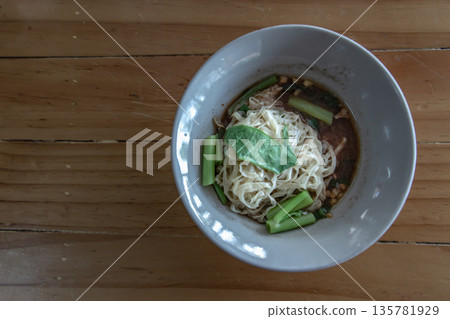 Thai boat noodle soup (Kuaytiaw reua) This delicious Thai noodle soup Local food in Thailand that can be eaten in general is delicious and cheap, Braised pork noodles on the wooden table, Boat culture Thai boat noodle soup (Kuaytiaw reua) This delicious Thai noodle soup Local food in Thailand that can be eaten in general is delicious and cheap, Braised pork noodles on the wooden table, Boat culture 135781929