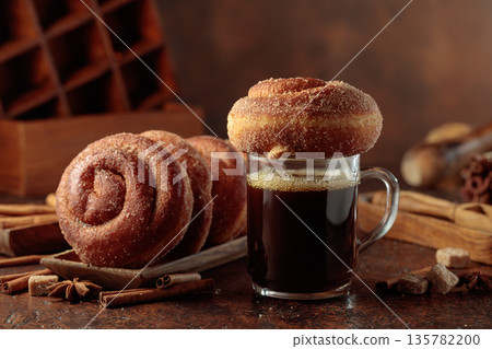 Swedish cinnamon rolls and mug of black coffee. Swedish cinnamon rolls and mug of black coffee. 135782200