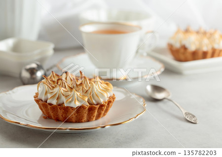 Meringue tart on a white marble countertop. Meringue tart on a white marble countertop. 135782203