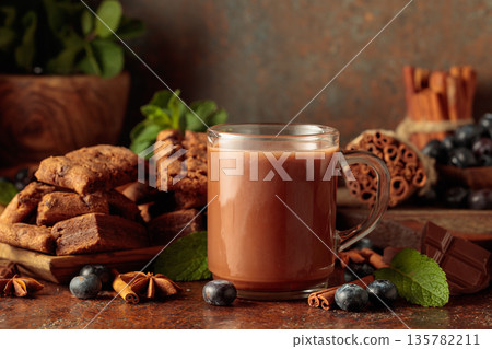 Brownie, mug of chocolate drink, fresh blueberries and mint. Brownie, mug of chocolate drink, fresh blueberries and mint. 135782211