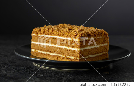 Traditional honey cake on a black background. Traditional honey cake on a black background. 135782232