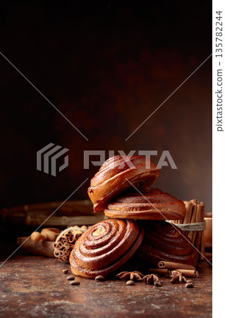 Freshly baked sweet cinnamon buns. Freshly baked sweet cinnamon buns. 135782244