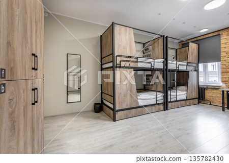 Spacious hostel dormitory with private wood-paneled bunk beds Spacious hostel dormitory with private wood-paneled bunk beds 135782430