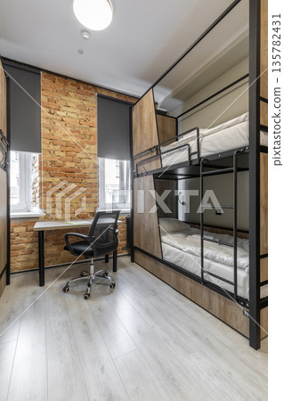 Modern loft style hostel room with wooden bunk beds and brick wall Modern loft style hostel room with wooden bunk beds and brick wall 135782431