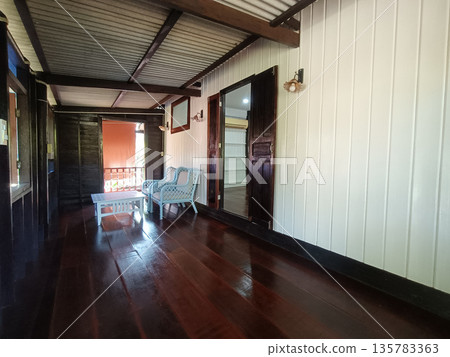 Wooden porch, rustic cabin, veranda, wicker chair, coffee table, wooden floor, exterior corridor with warm light Wooden porch, rustic cabin, veranda, wicker chair, coffee table, wooden floor, exterior corridor with warm light 135783363