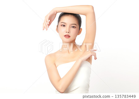 Beautiful Young Asian woman Raises her hands to Showcase clean and hygienic underarms Against a white background, Smooth armpit cleanliness and protection concept Beautiful Young Asian woman Raises her hands to Showcase clean and hygienic underarms Against a white background, Smooth armpit cleanliness and protection concept 135783449