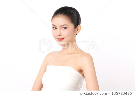 A beautiful young Asian woman with clean, fresh skin against a white background. Skincare, facial treatment, cosmetology, beauty, and spa. An elegant portrait of an Asian woman. 135783450